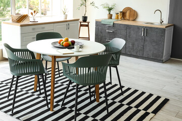 Interior of stylish room with dining table and counters