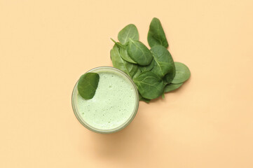 Glass of fresh spinach smoothie on yellow background