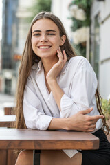 Fototapeta premium Portrait of a young beautiful woman in white shirt
