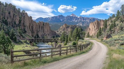 A narrow path guides visitors toward the parking area of Yellowstone National Park, featuring a wooden bridge and vibrant grass beside a small stream