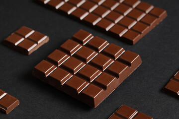Composition with tasty chocolate bars on dark background