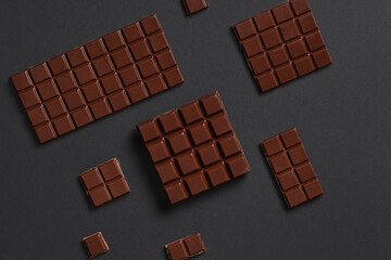 Composition with tasty chocolate bars on dark background