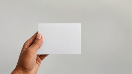 Hand holding blank white card is positioned way Hand holding a b
