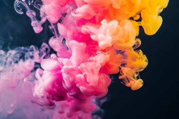 Obraz premium abstract colorful ink or smoke swirling in water, creating dynamic, flowing shapes, bright pink, yellow, and red hues contrasted against a deep blue black background