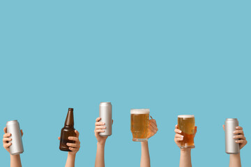 Female hands with fresh beer in mug, pint, cans and bottle on blue background