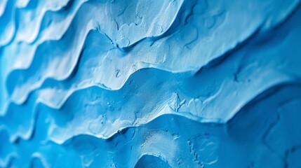 Obraz premium A vibrant blue accent wall with a raised texture reminiscent of ocean waves crashing against the shore.