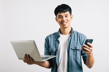 Portrait Asian smiling young man holding laptop and mobile phone studio isolated white background, Happy excited lifestyle businessman using computer and smartphone, modern technology and importance