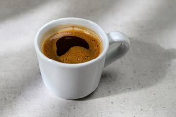 Beautiful coffee cup on the table top in a modern home kitchen.