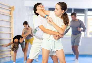 Children in sparring improve skill of performing strangulation and neutralizing enemy during krav...