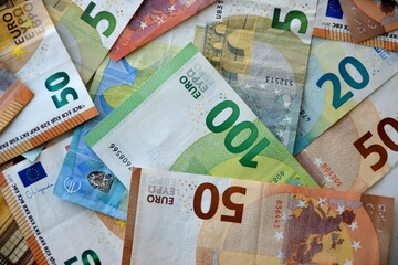 Many european euro money bills in chaotic arrangement. Pile of eur banknotes with different colors and condition