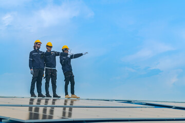 Worker Technicians are working to construct solar panels system on roof. Installing solar photovoltaic panel system. Men technicians walking on roof structure to check photovoltaic solar modules.