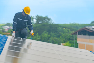 engineer man inspects construction of solar cell panel or photovoltaic cell by electronic device. Industrial Renewable energy of green power. factory worker working on tower roof.