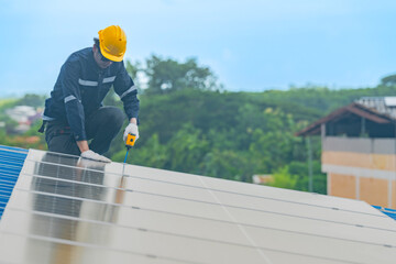 engineer man inspects construction of solar cell panel or photovoltaic cell by electronic device. Industrial Renewable energy of green power. factory worker working on tower roof.