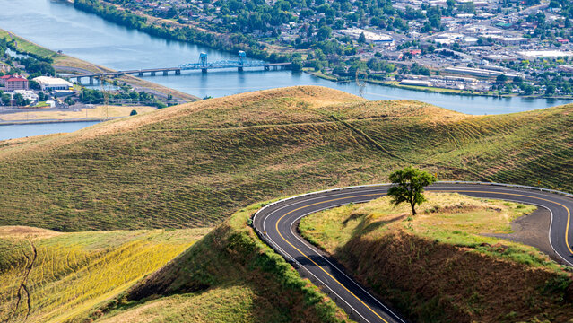 Overview of Lewiston Idaho and Clarkston Washington bridge Snake River with curvy road in foreground
