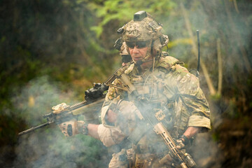 A group of military men in combat gear patrol in the middle of a desert and tropical jungle....