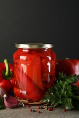 Tasty pickled vegetables in jar and fresh ingredients on wooden table