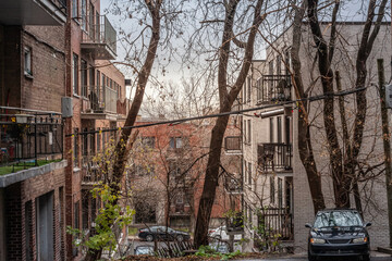 typical north american suburban mid-income small red brick buildings, condo style, taken on the district of Cote des Neiges, in Montreal, Quebec with the architectural style urban planning of the area