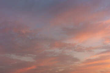 Serene Sunset Sky with Warm Color Gradients and Soft Clouds