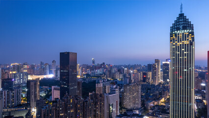 Obraz premium Stunning Nighttime Cityscape with Illuminated Skyscrapers