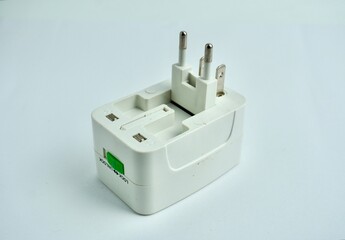 Foldable electrical plug with multiple plug types. Item to carry while traveling. Object photography isolated on white background.