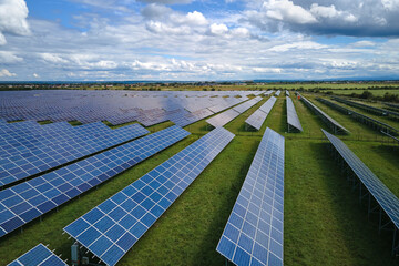Aerial view of big sustainable electric power plant with many rows of solar photovoltaic panels for...