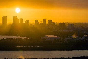 Fototapeta premium Aerial view of downtown district of Tampa city in Florida, USA at sunset. Dark silhouette of high skyscraper office buildings in modern american midtown