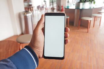 young man hand using smart phone with empty screen at cafe 