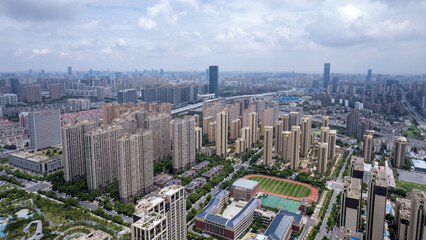 Fototapeta premium Aerial View of Urban Landscape Featuring Modern Architecture and Green Spaces