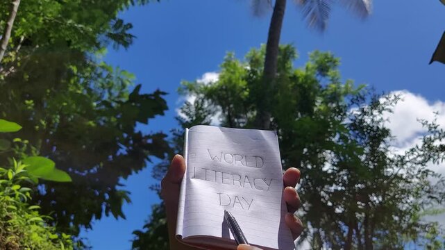 african american man is hand holding book international literacy day concept close up, poverty country literacy, niger ,ethiopia poor man literacy, starve country young man education , reading letters