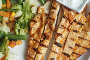 Enjoy Grilled Chicken with Mixed Vegetables and a refreshing Yogurt Dip on the side