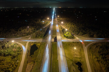 Elevated view of freeway exit junction over road lanes with fast moving traffic cars and trucks at...