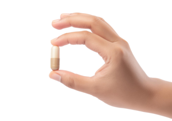 Hand holding capsule isolated on a transparent or white background