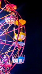 Vibrant Ferris wheel at night, symbolizing joy, nostalgia, and the excitement of amusement parks...