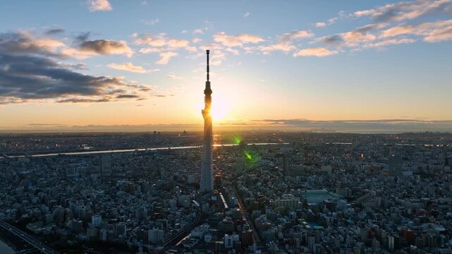 Aerial view of Tokyo metropolis and sunrise over the city skyline..Take off