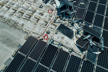 Photovoltaic solar panels destroyed by hurricane strong wind mounted on industrial building roof...