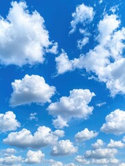 Obraz premium Fluffy white clouds in a bright blue sky