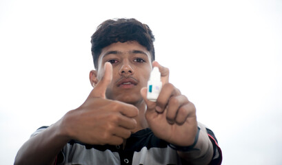 eye flu, acute conjunctivitis patient, asian patient has red eyes and feeling pain, infection eye, thumbs up with eye drops