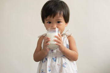 Girl drinks milk from a glass The concept of drinking milk for good health