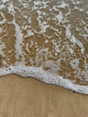 Ocean waves are hitting the shore on Rayong Beach. Take photos from a high angle