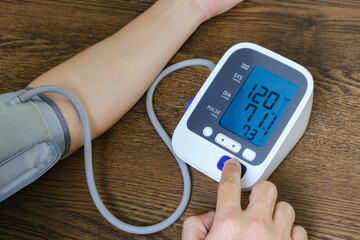 Man check blood pressure monitor and heart rate monitor with digital pressure gauge. Health care and Medical concept	