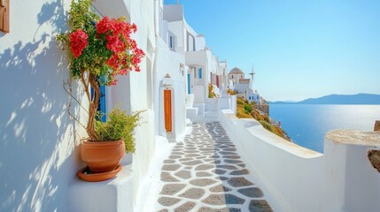 Fototapeta premium Whitewashed Greek Village Street with Red Flowers and Ocean View