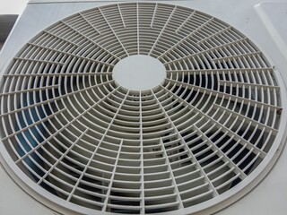 air conditioner fan behind grill close-up. selective focus