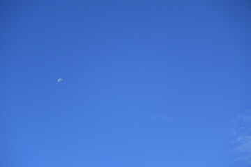 Moon in blue sky in early morning