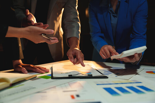Group of business people brainstorming in analytical plan meeting Calculate the numbers obtained from the graph. Financial growth chart. Marketing. Concept of business success statistics.
