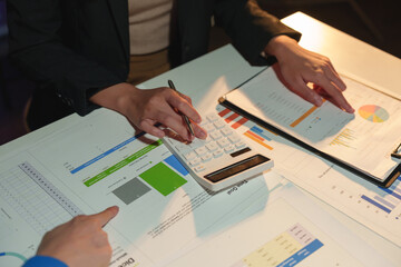 Group of business people brainstorming in analytical plan meeting Calculate the numbers obtained from the graph. Financial growth chart. Marketing. Concept of business success statistics.