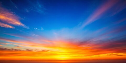 Fototapeta premium Vibrant sky gradient transitioning from blue to orange at sunset