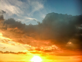 Blue yellow and gold gradient sky with clouds 