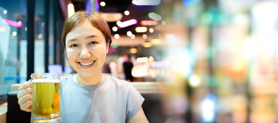 Asian beautiful woman enjoy eating a Korean Bar-B-Q and drinking a beer.