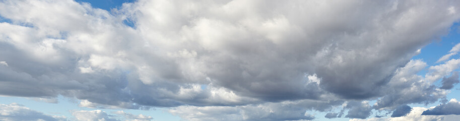 Panoramic photo of blurred sky. Blue sky background with cumulus clouds