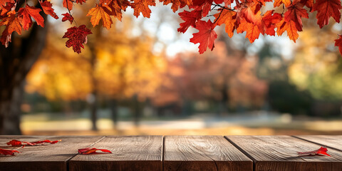 A beautiful display of vibrant autumn leaves hanging over a rustic wooden table set against the blurred background of a serene park landscape during fall season.